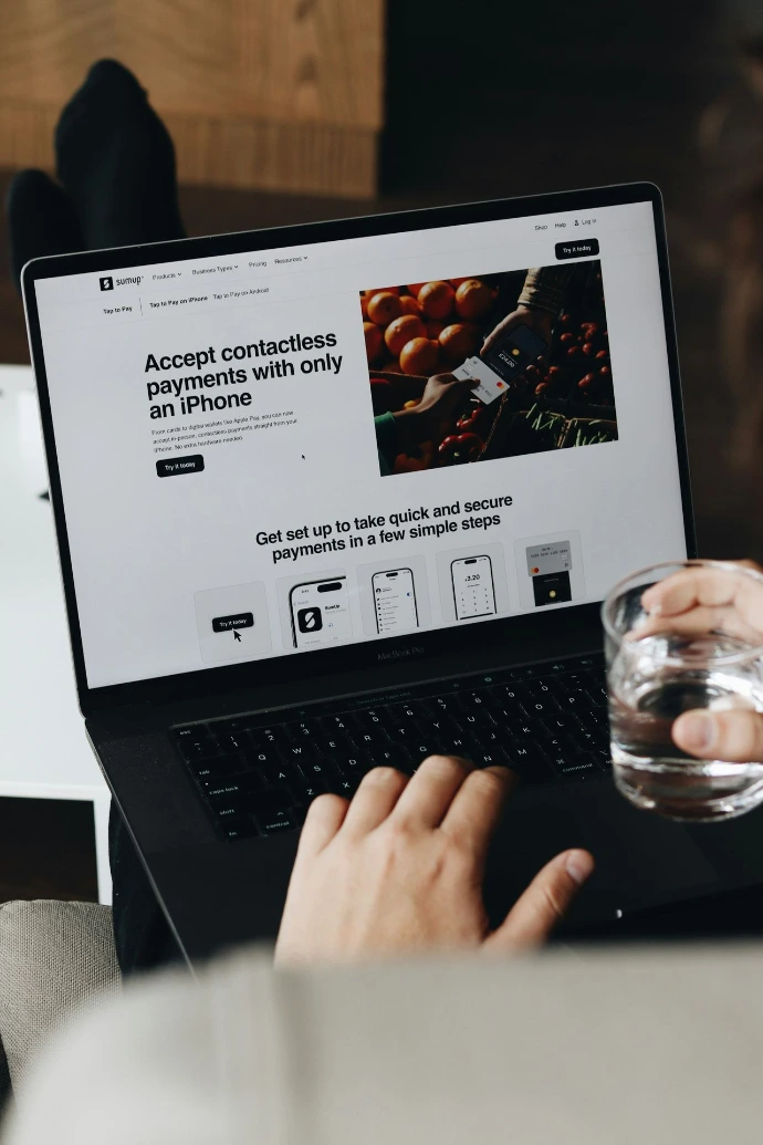 A person sitting on a couch using a laptop computer